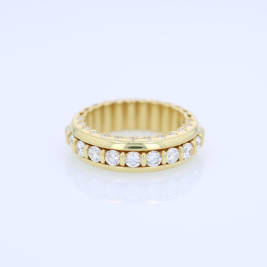 Yellow gold ring with diamond accents on a white background