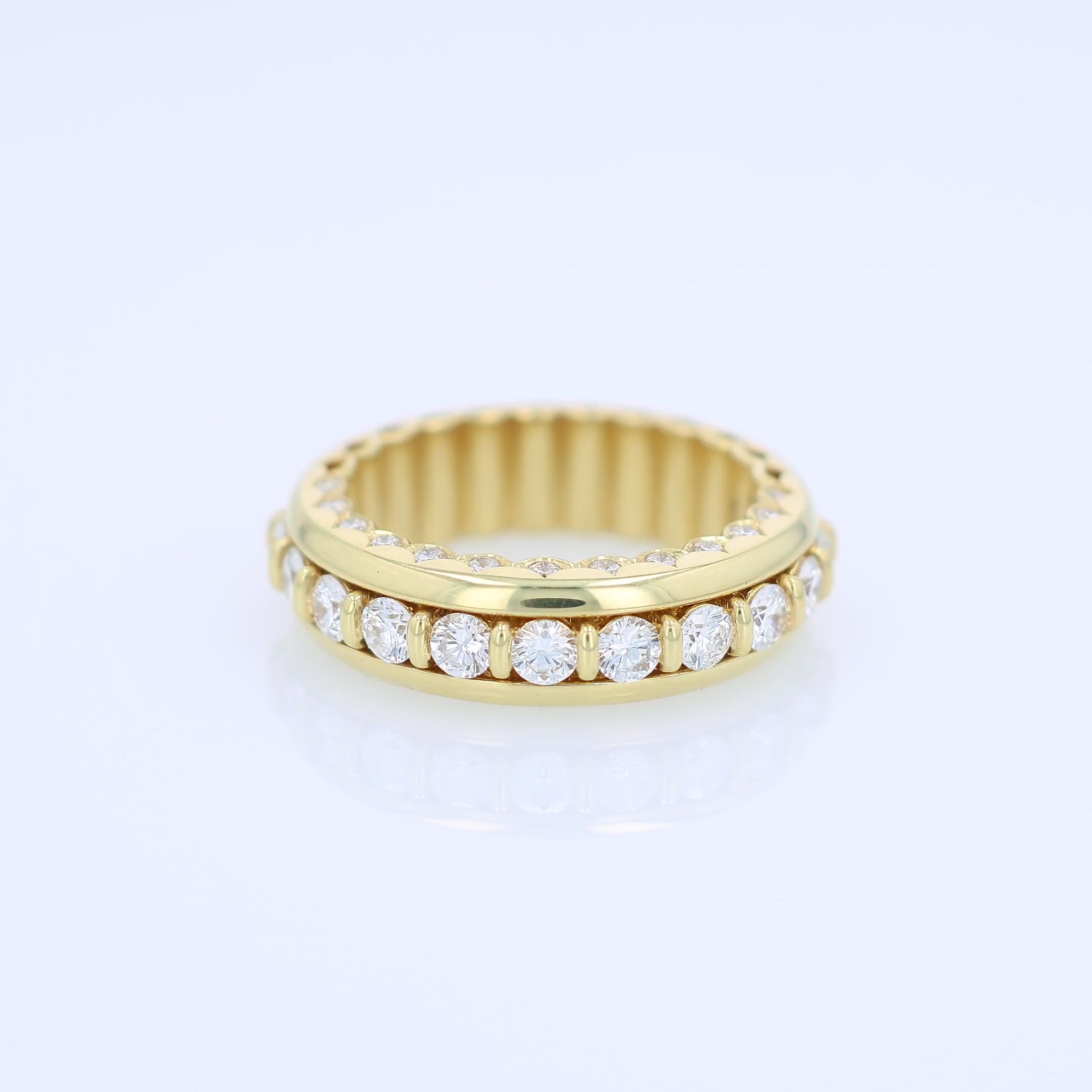 Yellow gold ring with diamond accents on a white background