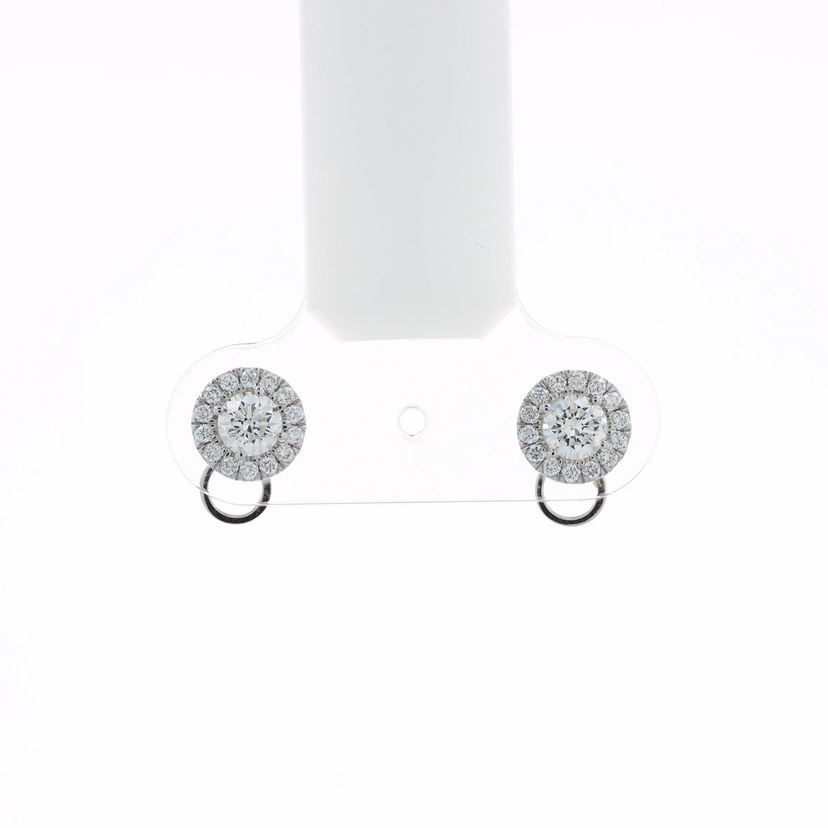 Video of a pair of round halo stud earrings with clear gemstones in a silver-toned setting and a small circular drop below, shown at various angles on a white background with soft reflections.