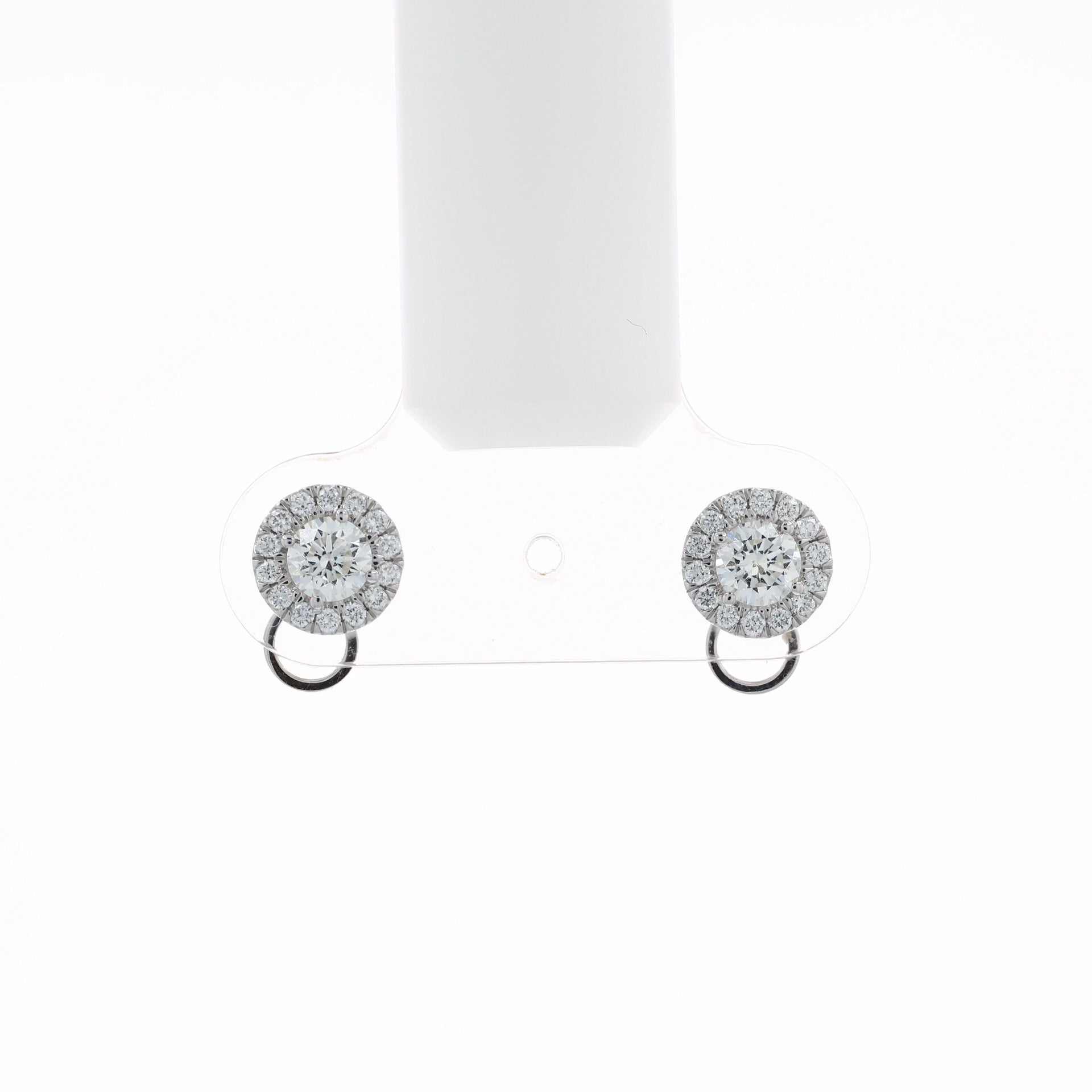 Video of a pair of round halo stud earrings with clear gemstones in a silver-toned setting and a small circular drop below, shown at various angles on a white background with soft reflections.