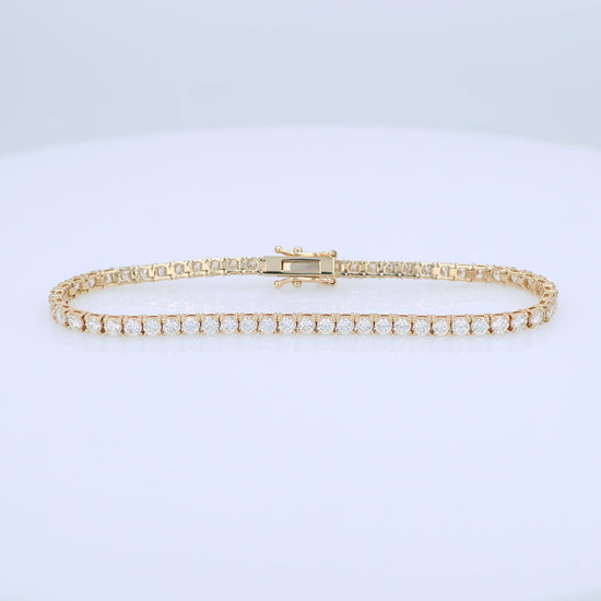 Yellow gold 4.27 carat diamond tennis bracelet on a white background