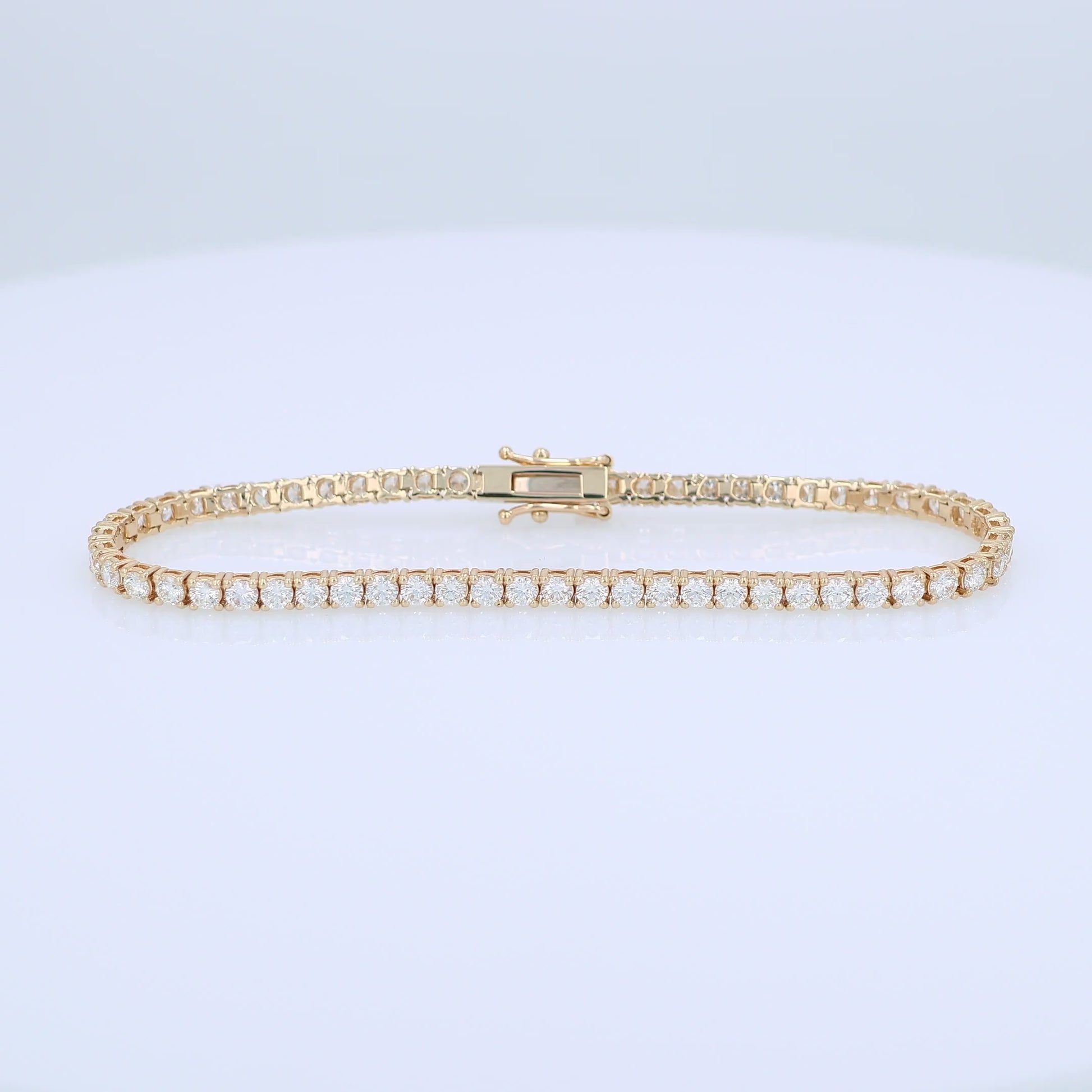 Yellow gold 4.27 carat diamond tennis bracelet on a white background
