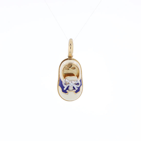 Yellow gold shoe charm pendant with  diamond on white gold bowtie on a white background