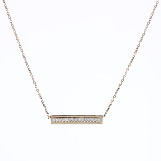 Yellow gold single row diamond bar pendant necklace on a white background