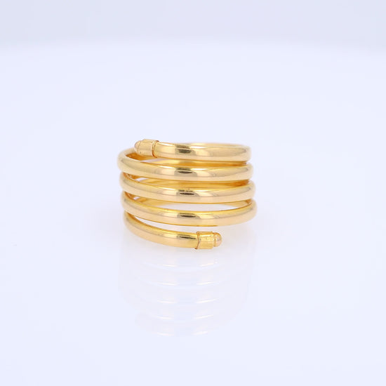 A gold wrap ring with multiple polished bands coiled around each other, shown on a clean white background.
