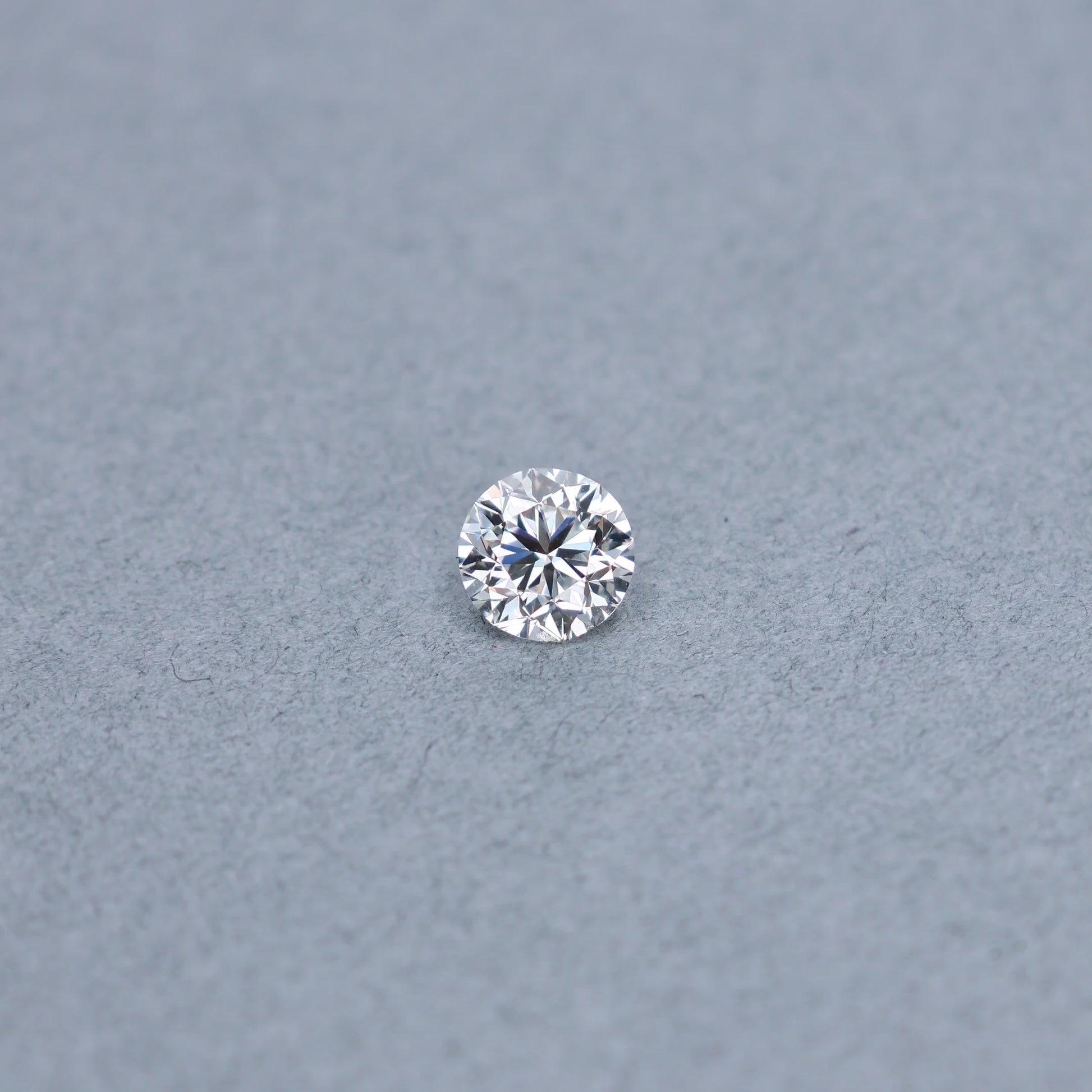 Round 1.51 carat GIA certified diamond graded HVS1 on a grey background