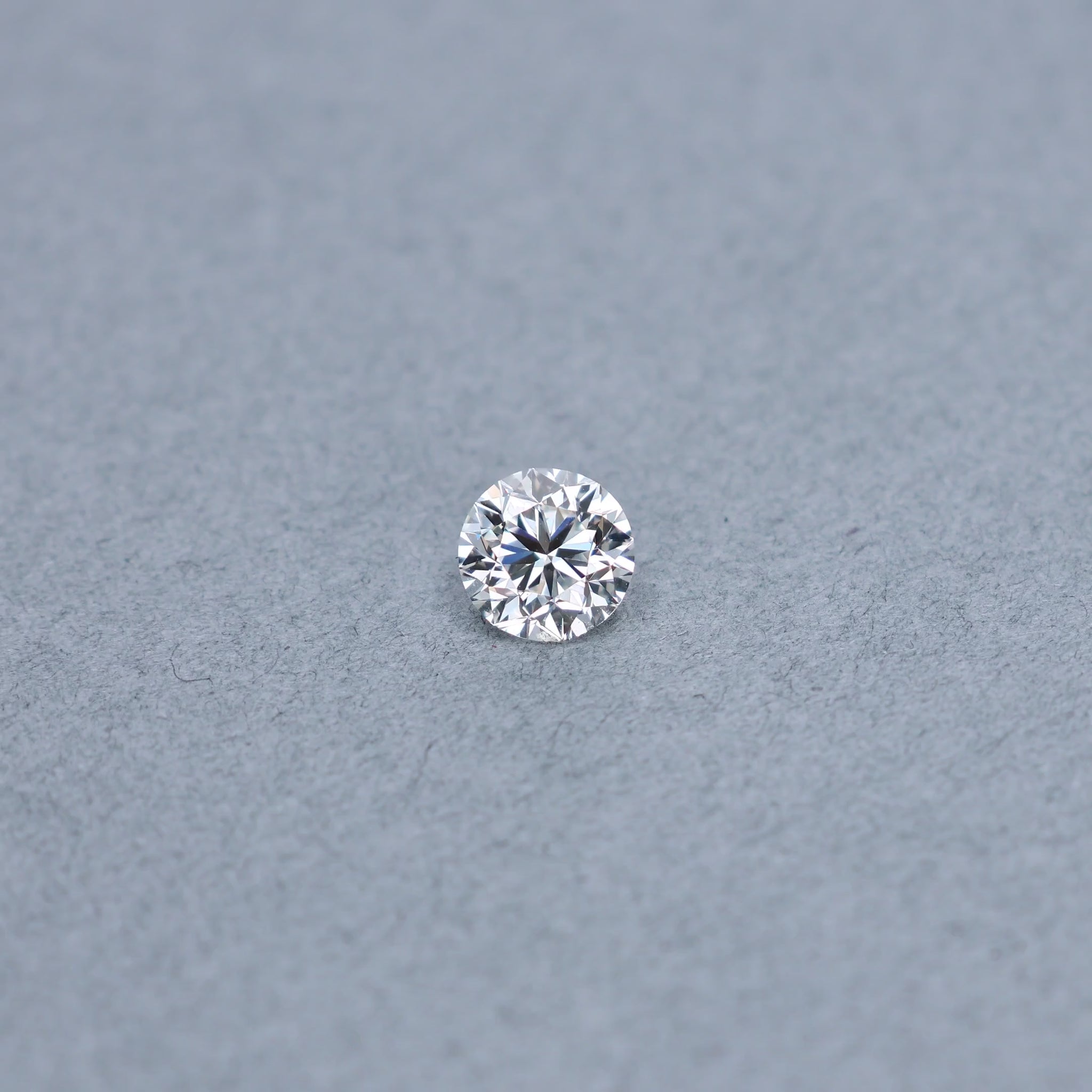 Round 1.51 carat GIA certified diamond graded HVS1 on a grey background