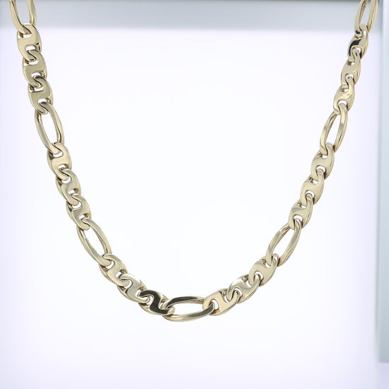 Yellow gold figaro link chain necklace on a white background