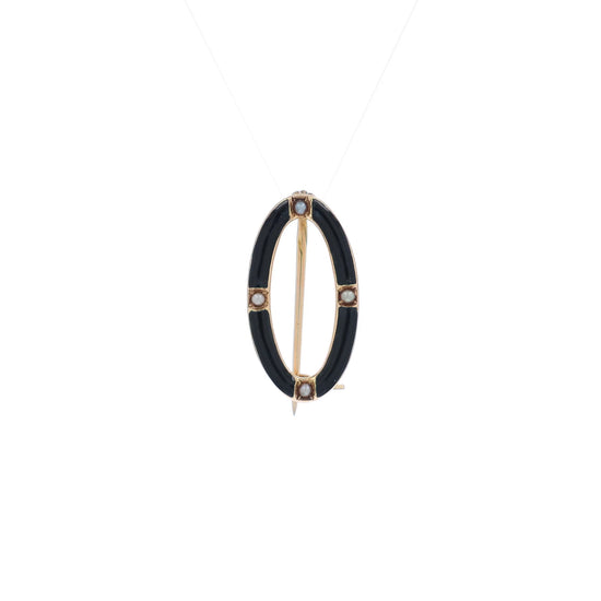 A video of a yellow gold and black enamel open oval seed pearl pin on a white background
