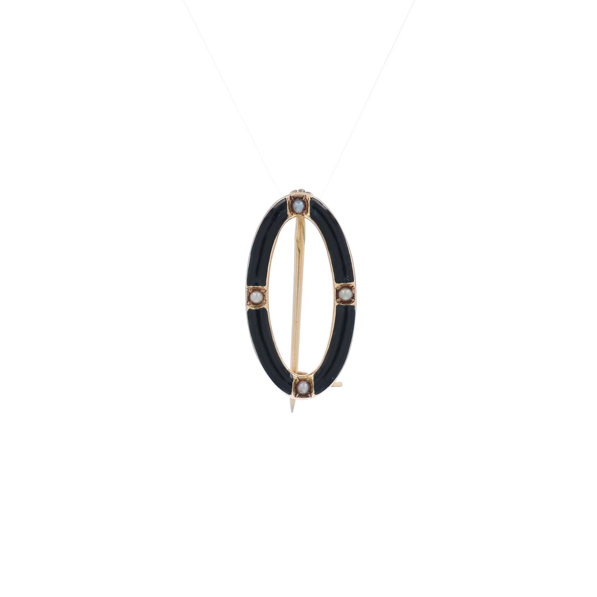 A video of a yellow gold and black enamel open oval seed pearl pin on a white background