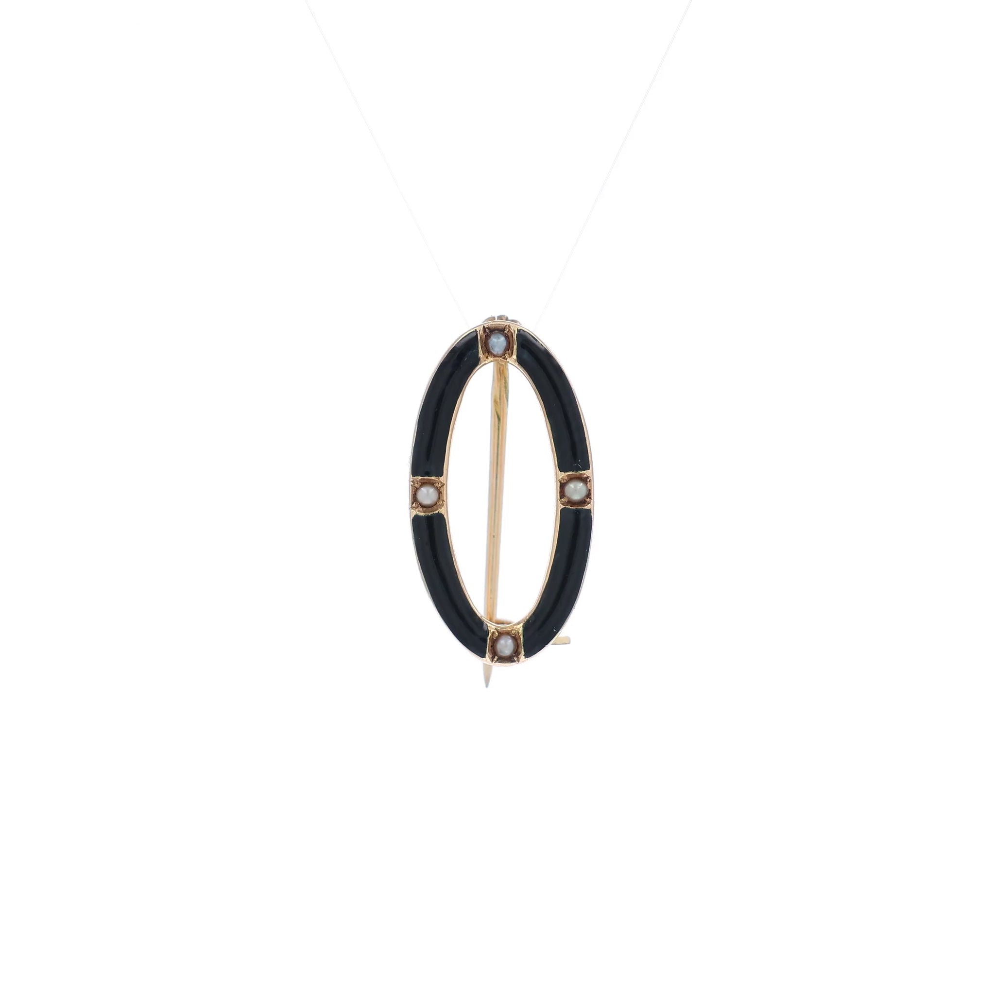 A video of a yellow gold and black enamel open oval seed pearl pin on a white background