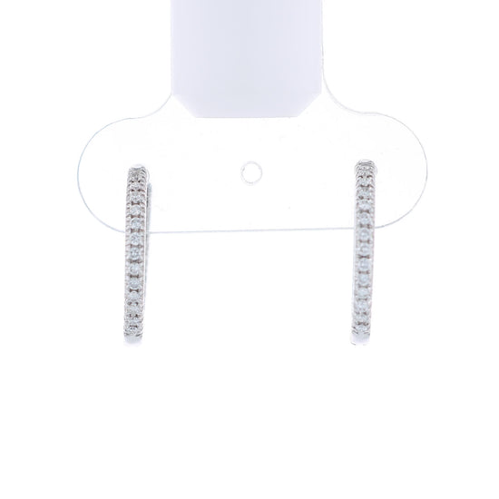 White gold diamond in and out hoop earrings on a white background
