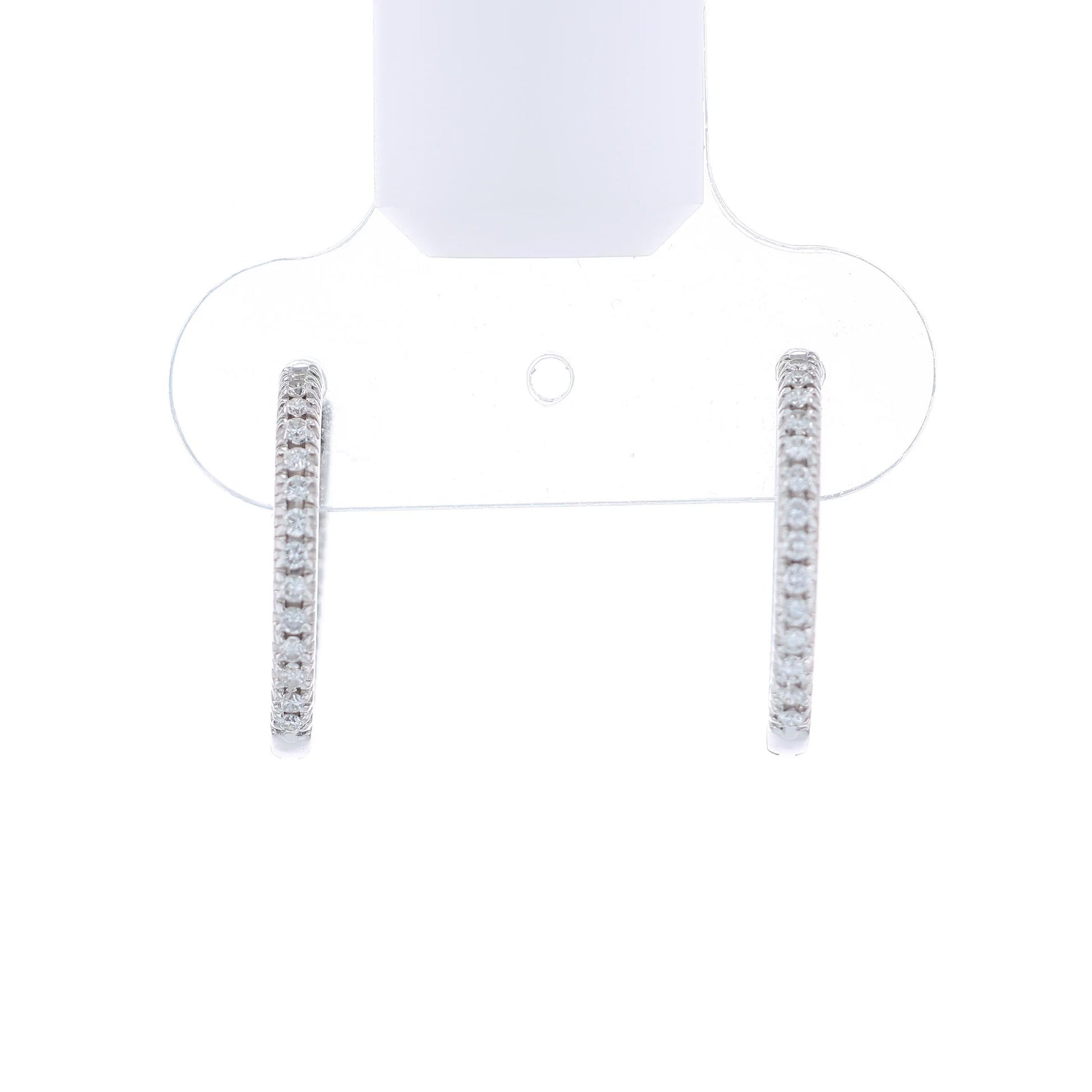 White gold diamond in and out hoop earrings on a white background