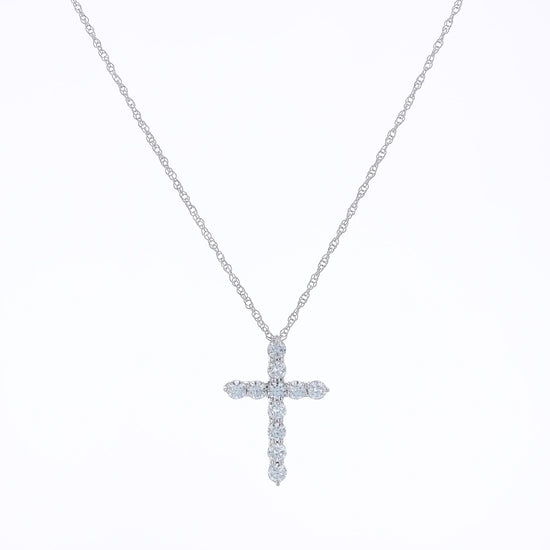 White gold cross pendant necklace with diamonds on a white background
