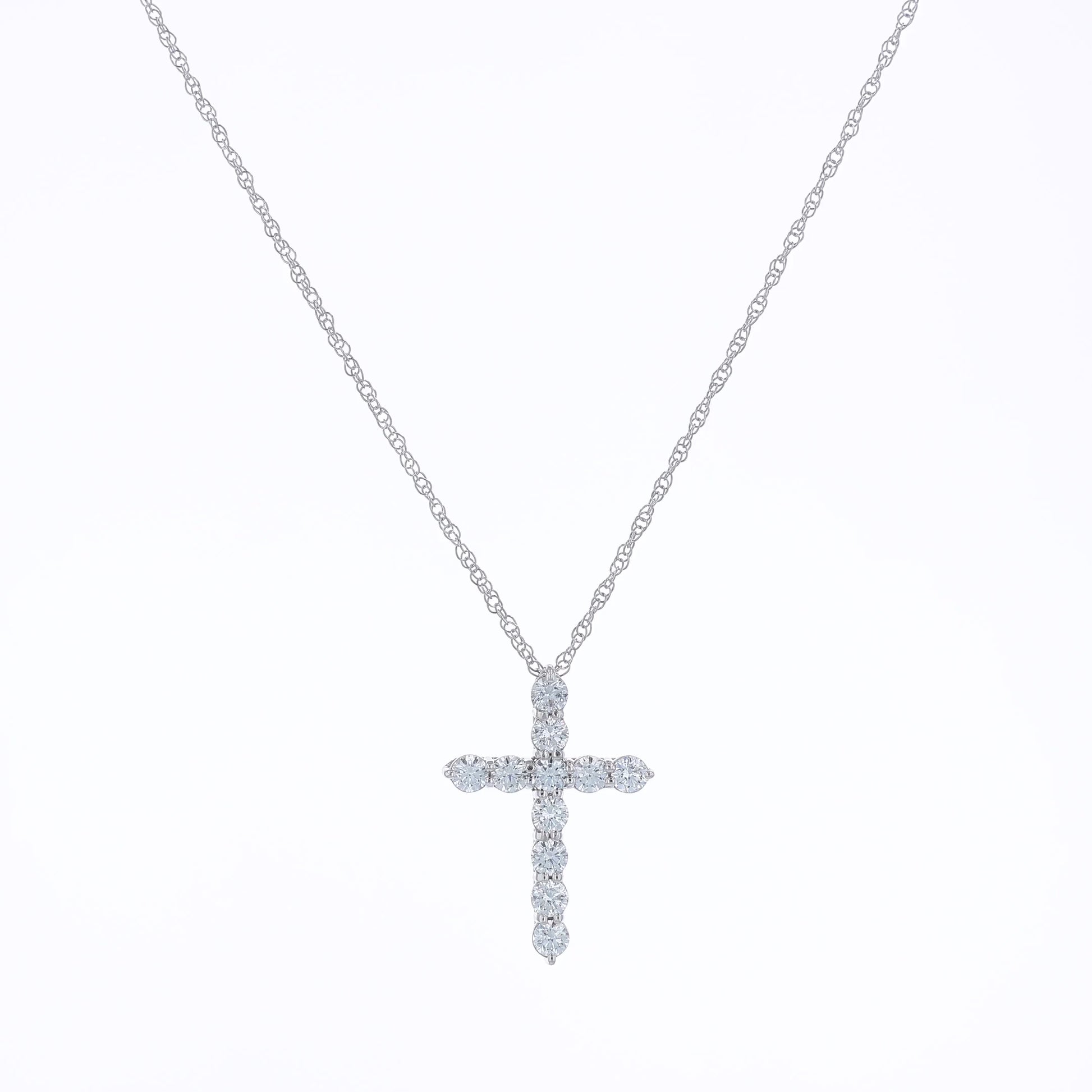 White gold cross pendant necklace with diamonds on a white background