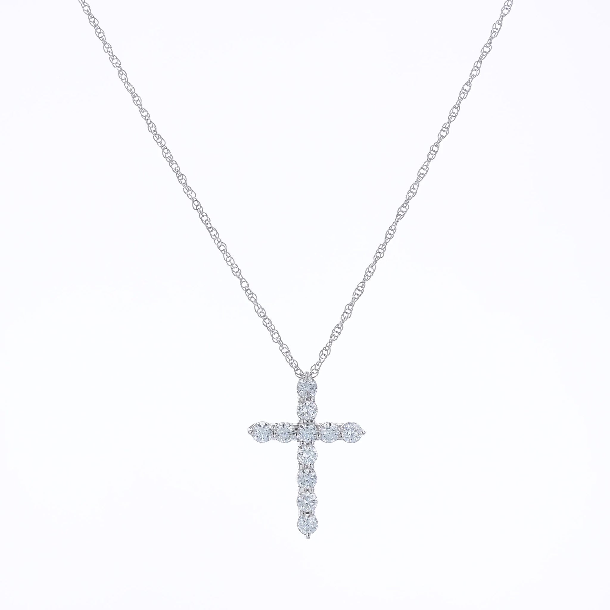 White gold cross pendant necklace with diamonds on a white background