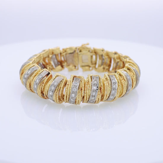 360 degree video of a textured two-tone gold bracelet with diamonds on a white background