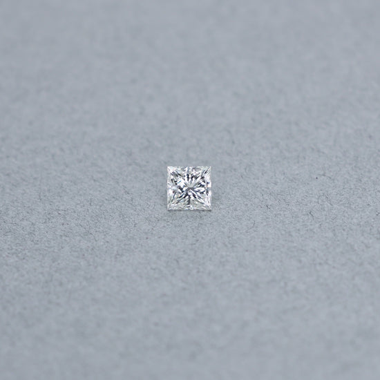 Princess cut 0.81 carat GIA certified diamond graded H IF on a grey background