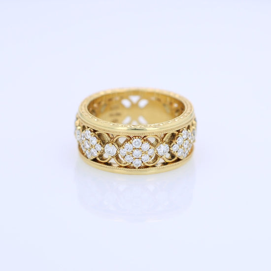Yellow gold ring with diamond accents on a white background