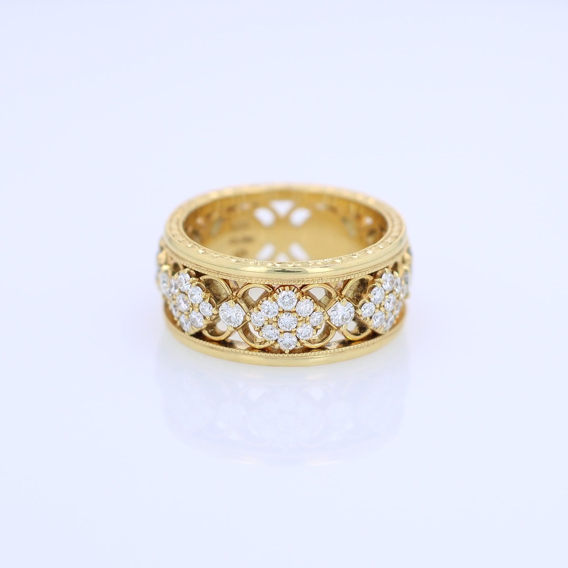 Yellow gold ring with diamond accents on a white background