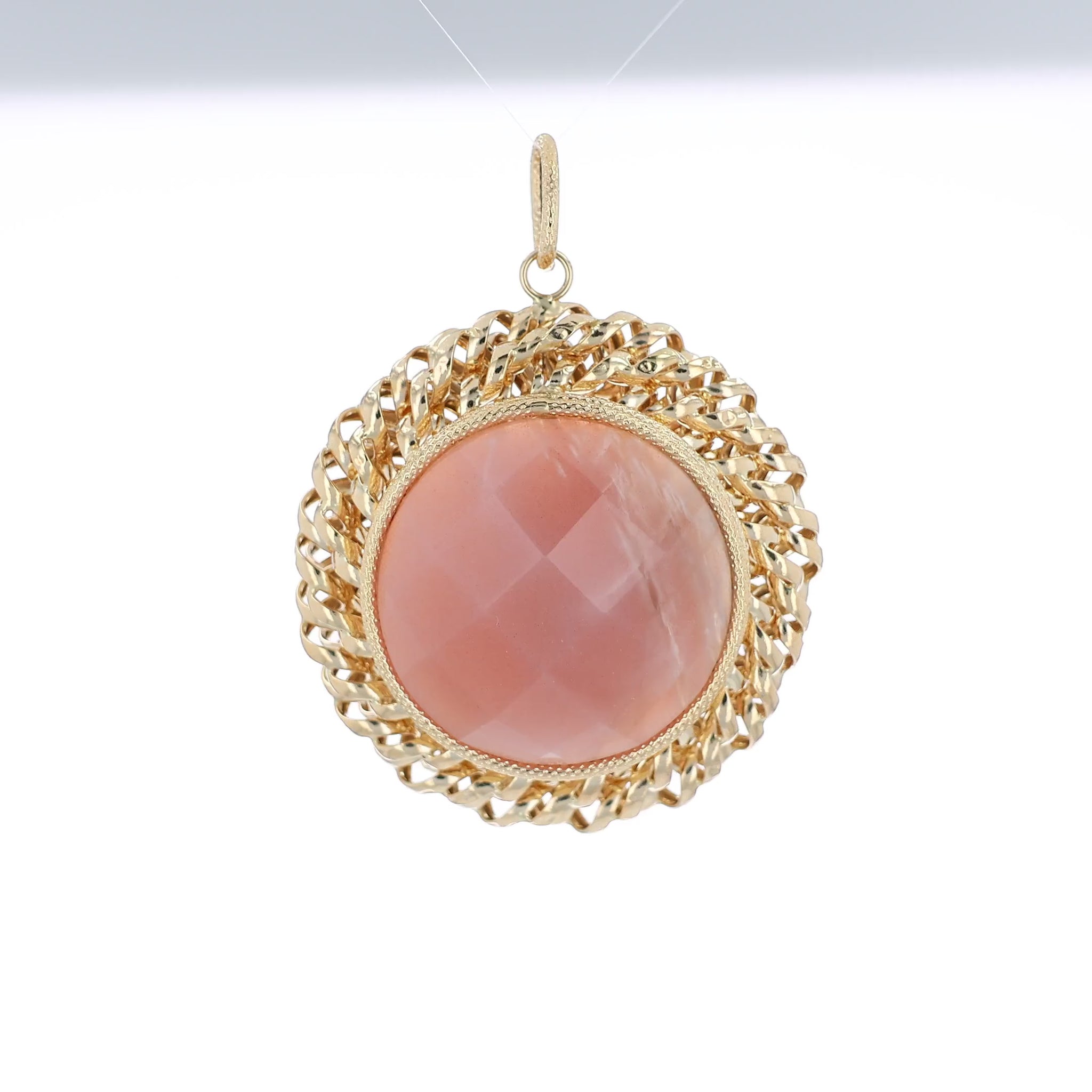 Yellow gold faceted round pink agate pendant with a textured rope border and a polished swirl frame on a white background
