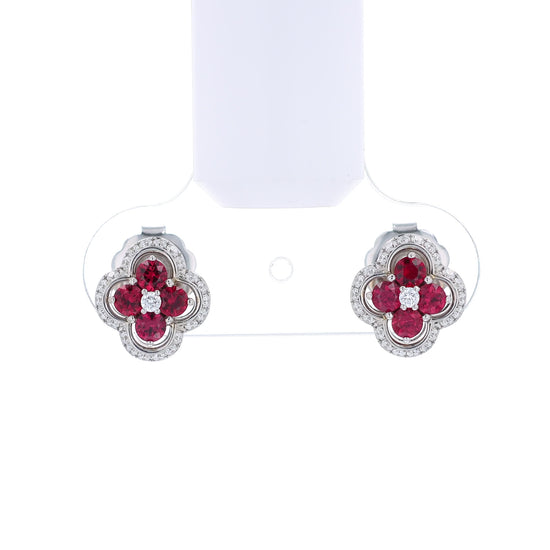 White gold stud earrings with diamond and ruby accents on a white background