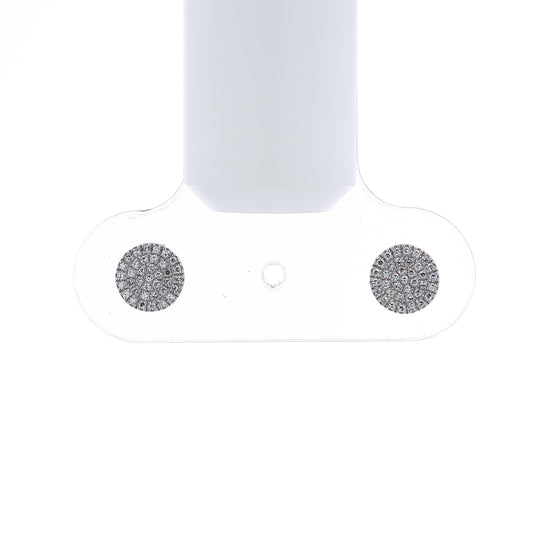 A pair of round pavé diamond stud earrings in white gold on a white background