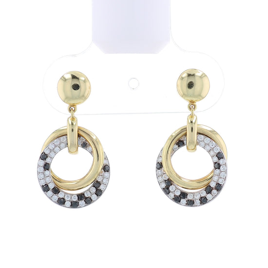 Two-tone gold drop earrings with entwined black and white diamond circles on a white background
