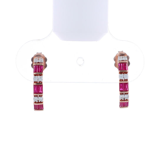 Rose gold alternating diamond and ruby hoop earrings on a white background