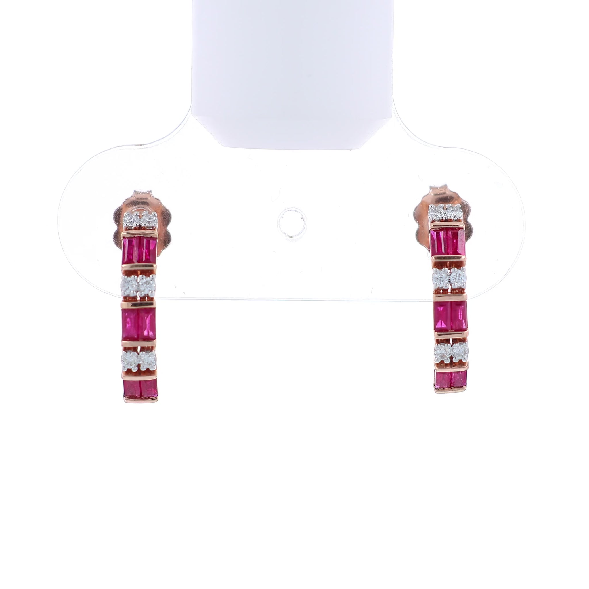 Rose gold alternating diamond and ruby hoop earrings on a white background