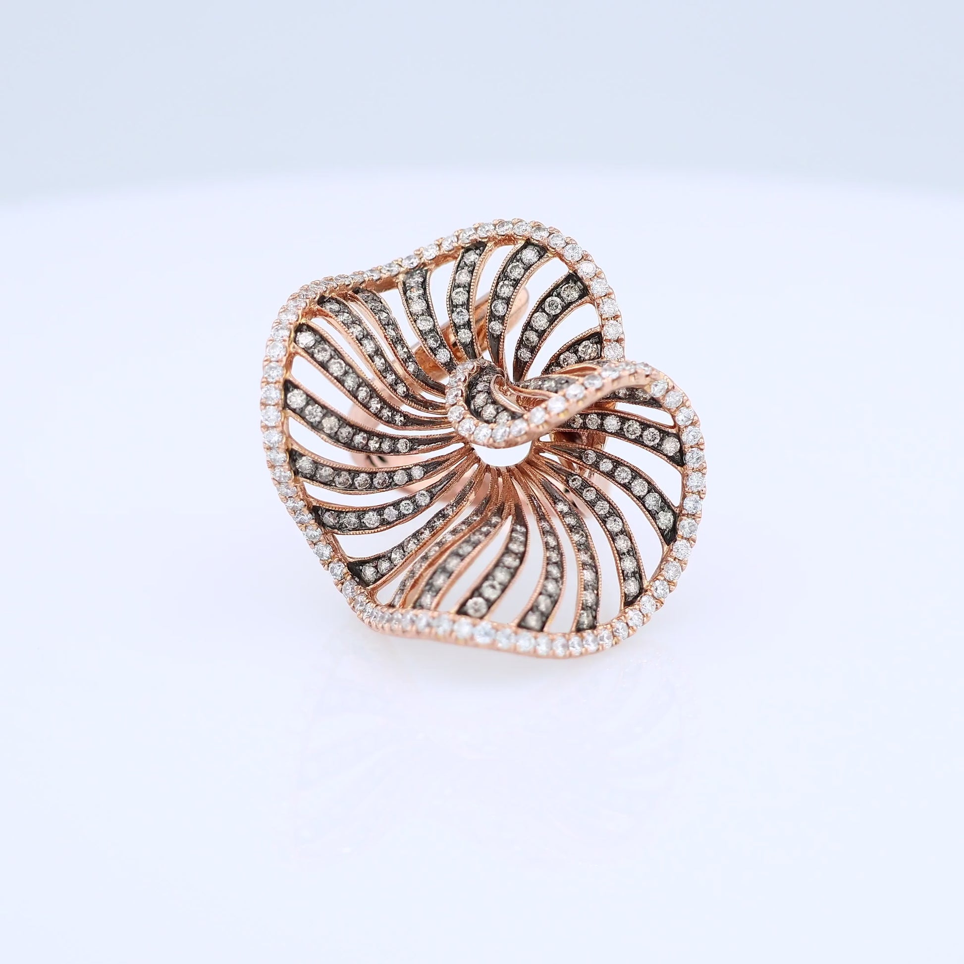 Rose gold white and brown diamond swirl design cocktail ring on a white background