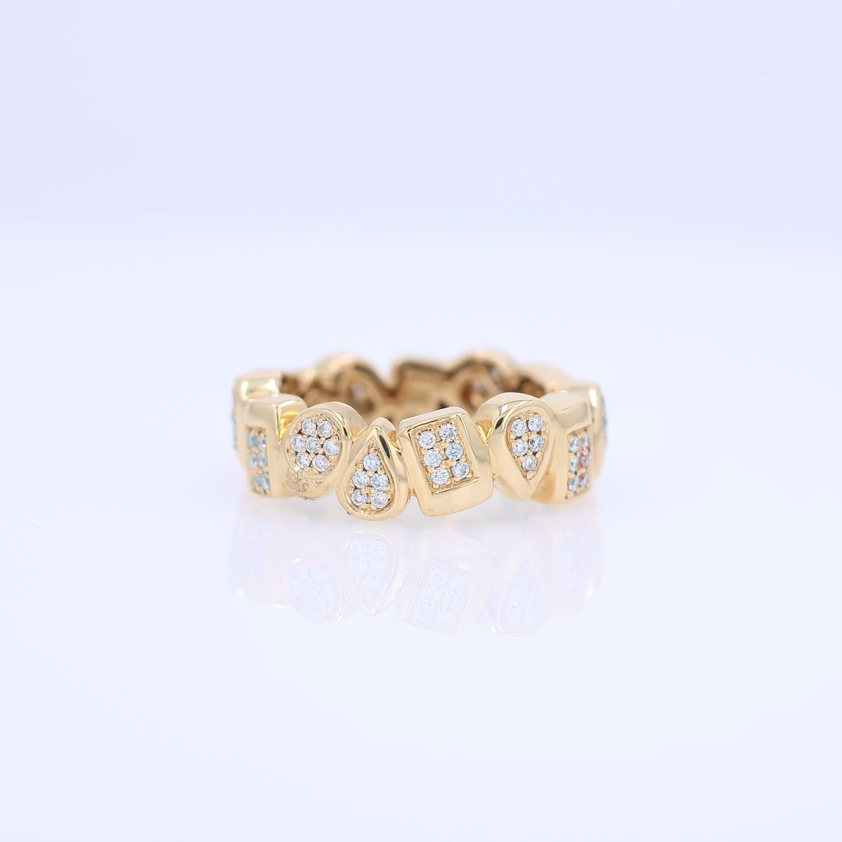 Yellow gold geometric shape design diamond eternity band on a white background