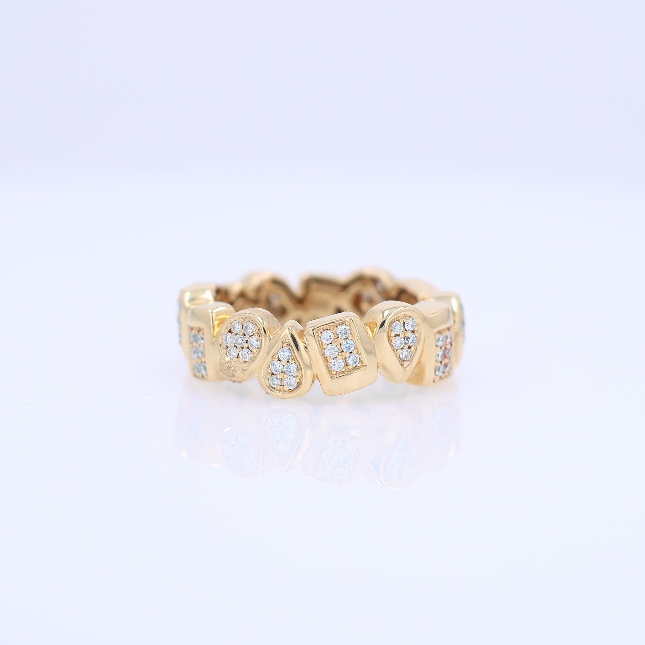 Yellow gold geometric shape design diamond eternity band on a white background