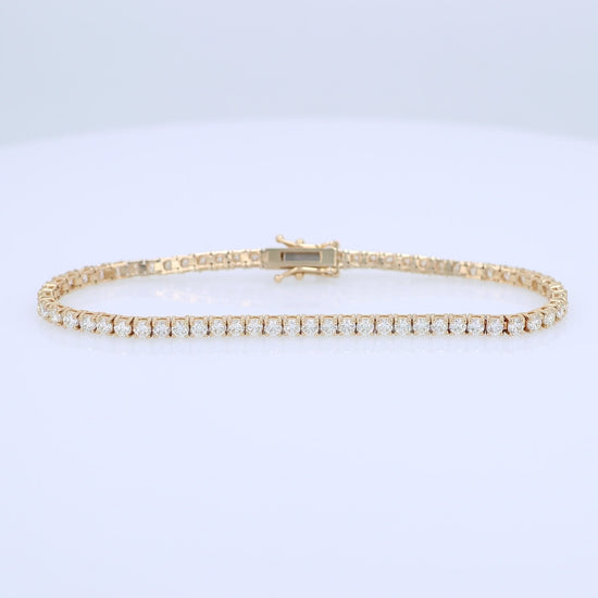 Yellow gold 4.15 carat diamond tennis bracelet on a white background