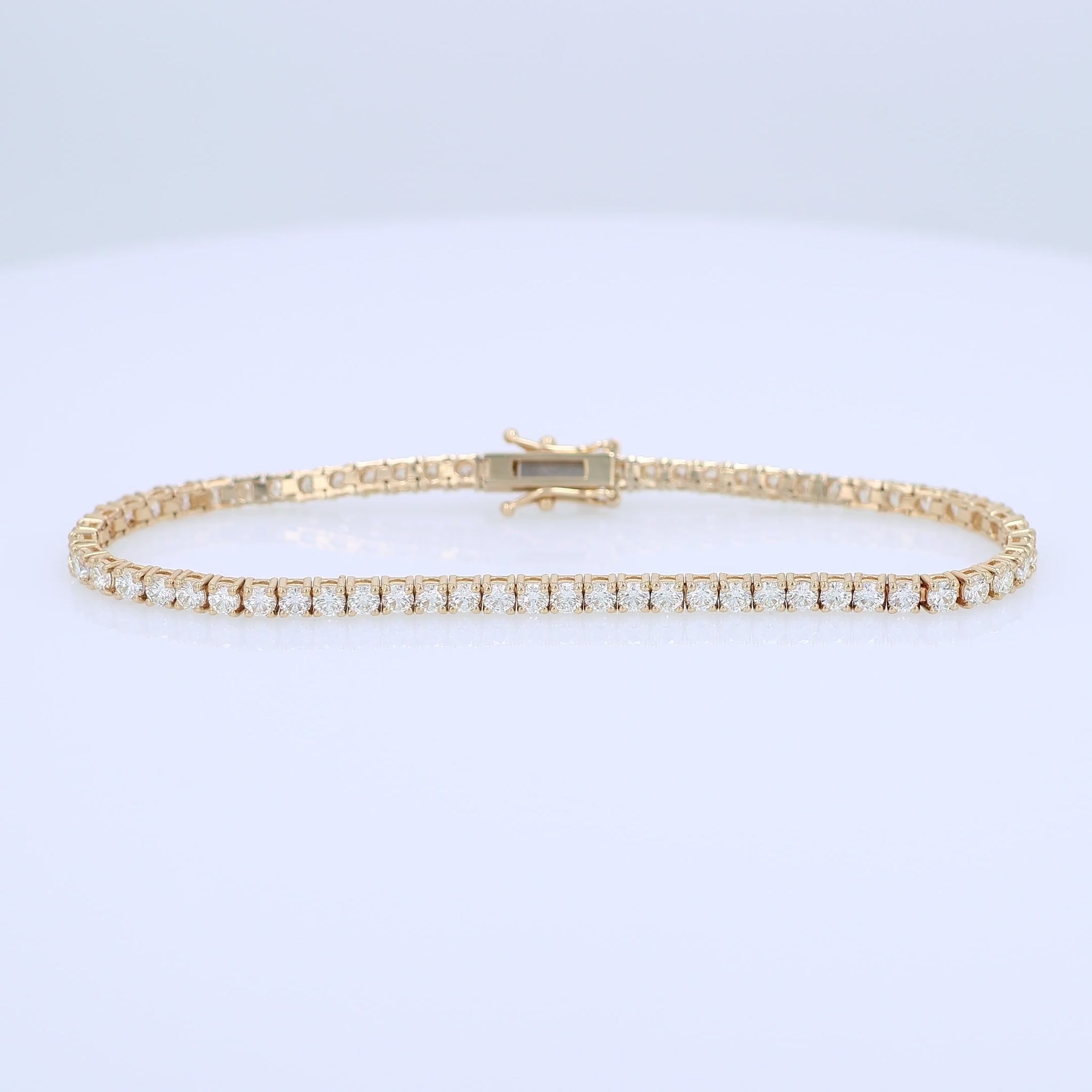 Yellow gold 4.15 carat diamond tennis bracelet on a white background