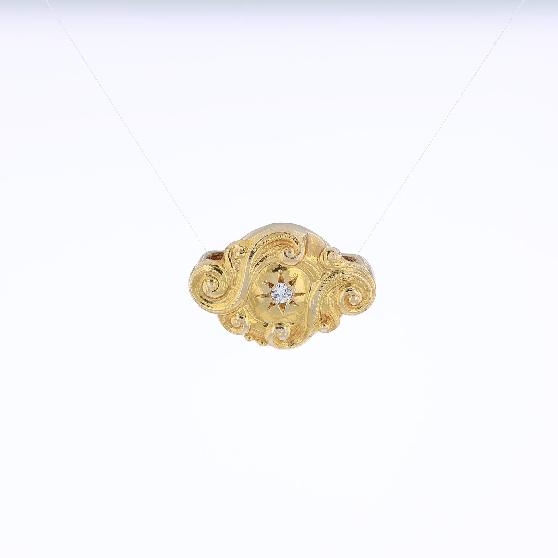 Yellow gold diamond Victorian slide pendant with a swirl design on a white background
