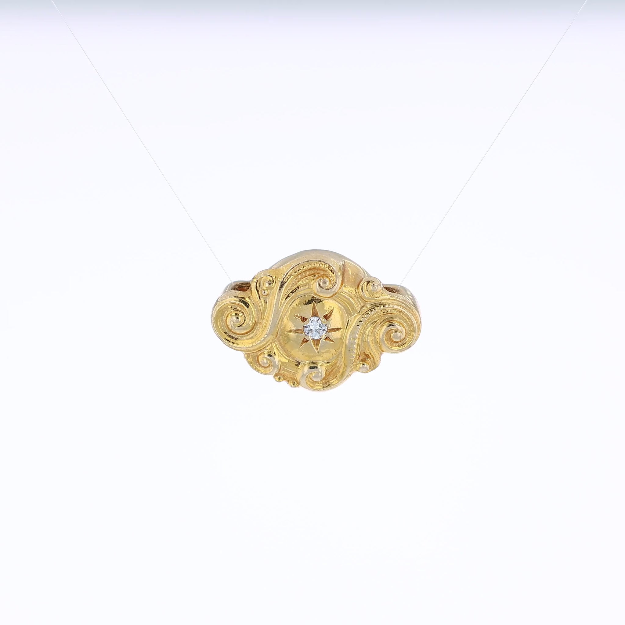 Yellow gold diamond Victorian slide pendant with a swirl design on a white background