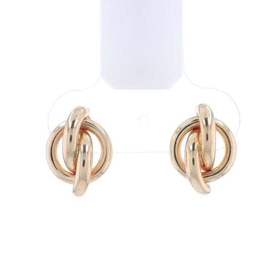 Gold knot earrings on a white background