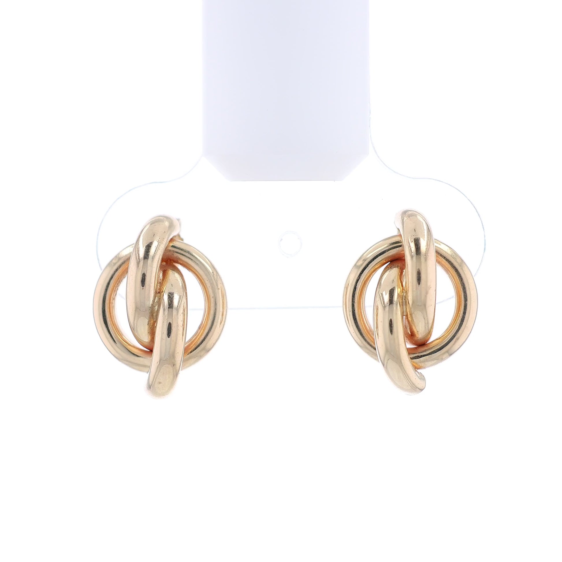 Gold knot earrings on a white background