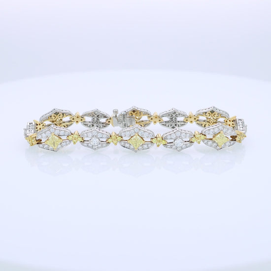 Two-tone bracelet with white and yellow diamond accents on a white background