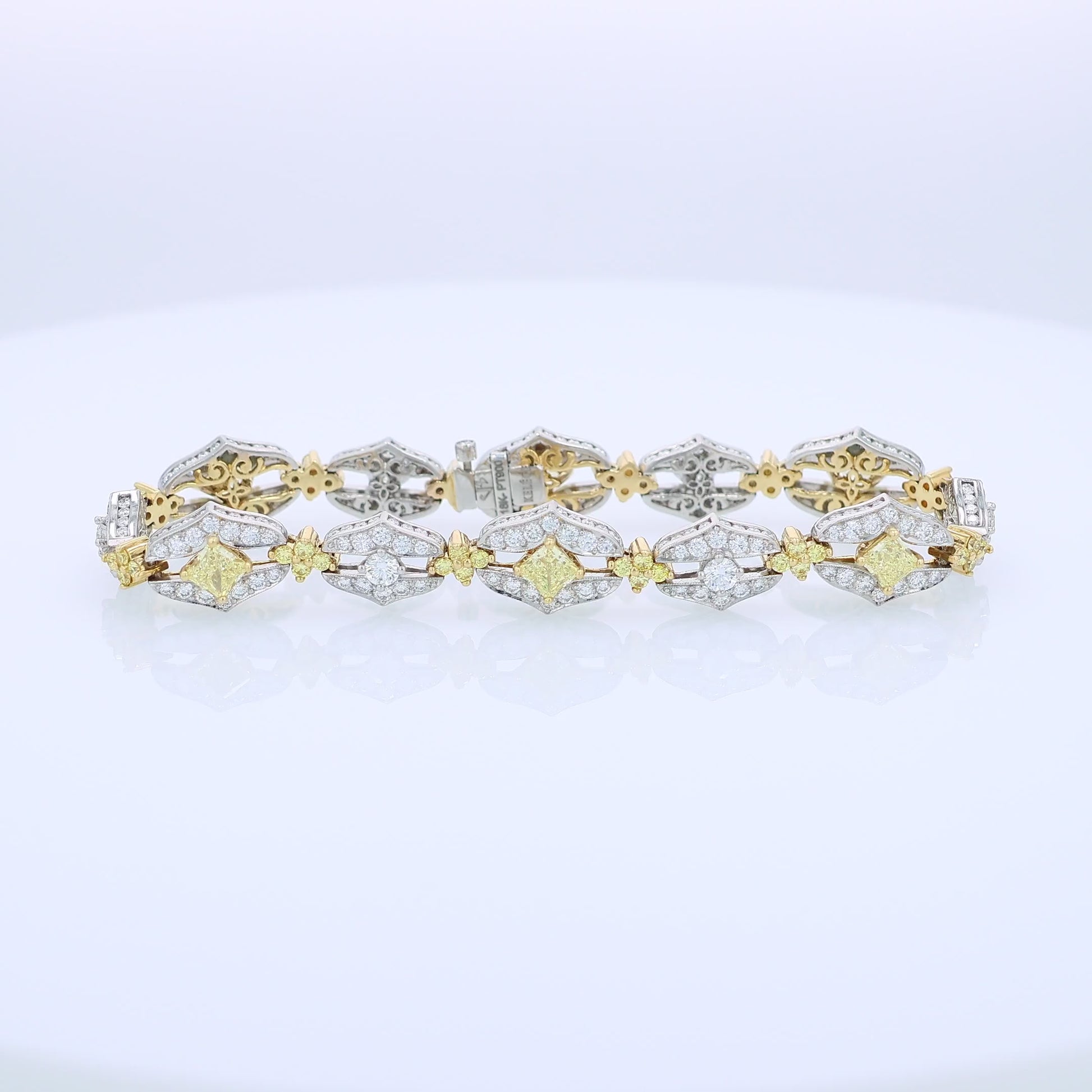 Two-tone bracelet with white and yellow diamond accents on a white background
