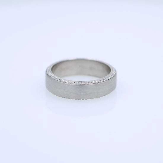 Platinum Simon G. wedding band with pave diamond edges and a brushed center on a white background