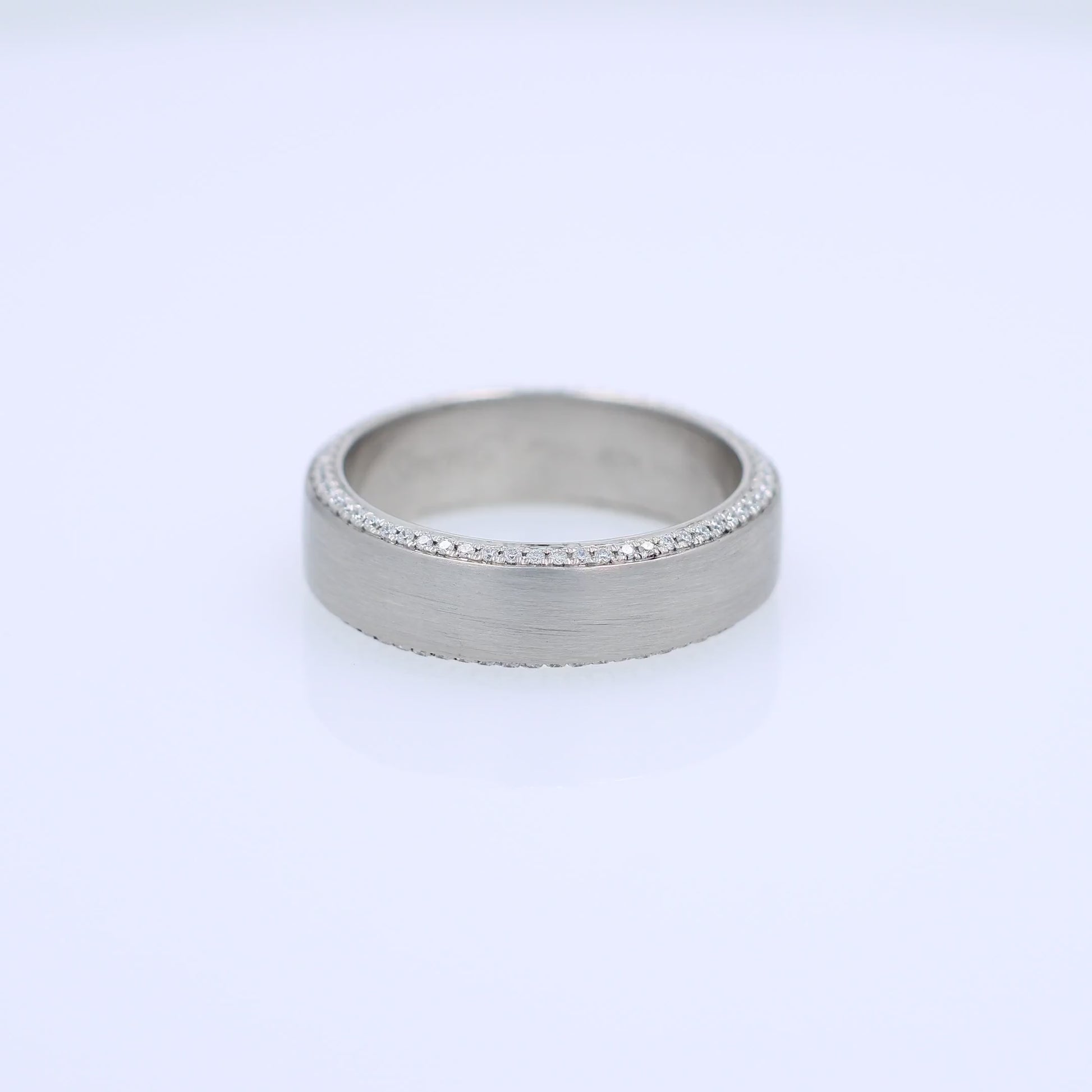 Platinum Simon G. wedding band with pave diamond edges and a brushed center on a white background