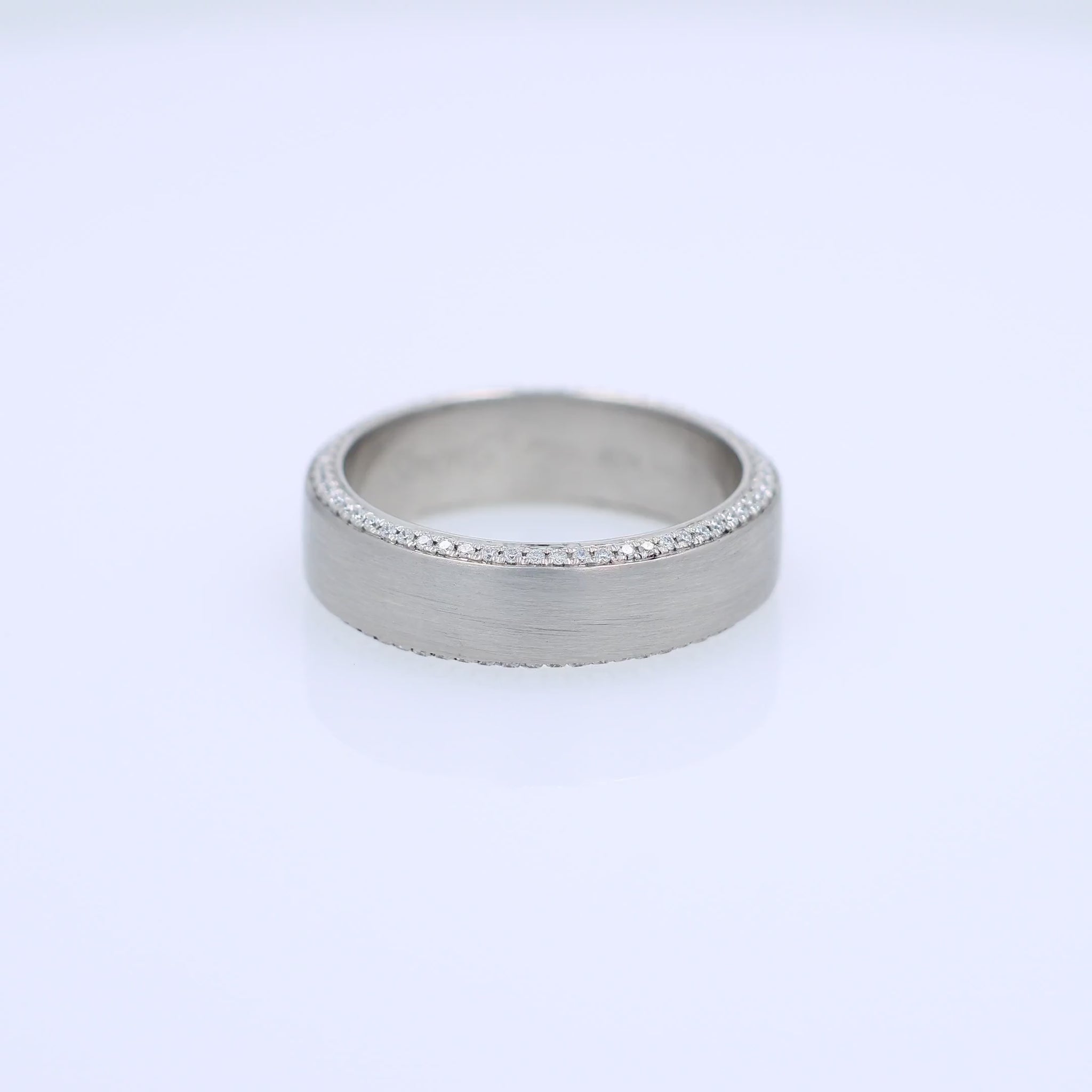 Platinum Simon G. wedding band with pave diamond edges and a brushed center on a white background
