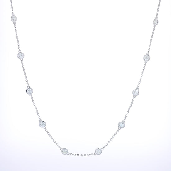 White gold bezel set Diamonds By The Yard station necklace on a white background