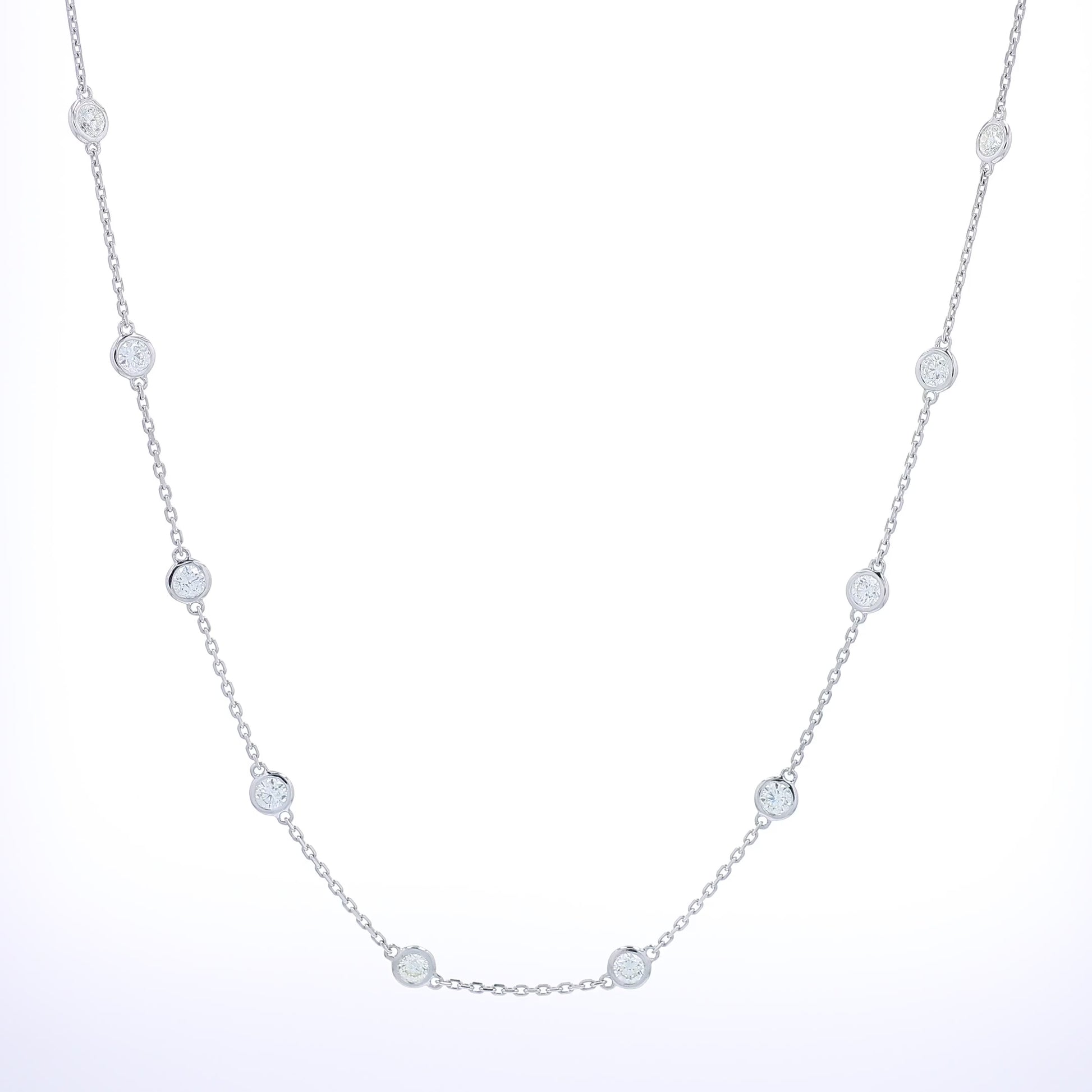 White gold bezel set Diamonds By The Yard station necklace on a white background