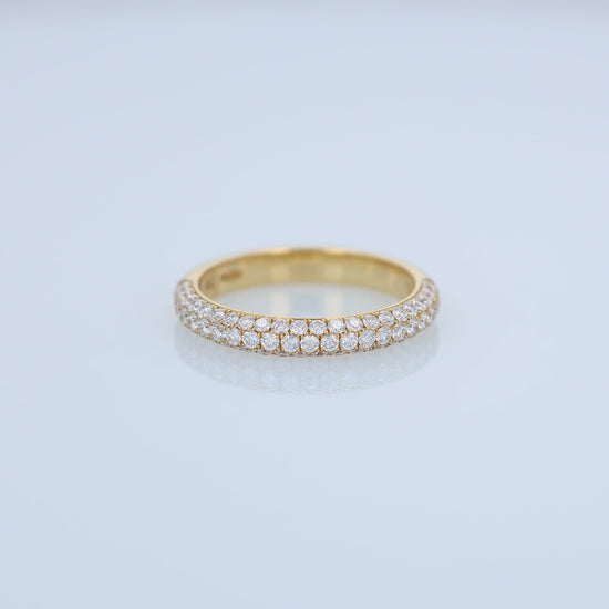 Yellow gold ring with embedded diamonds on a white background