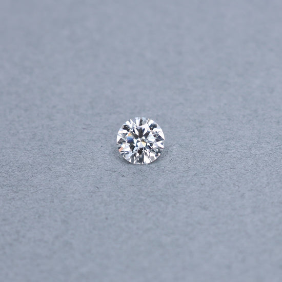 Round 1.50 carat GIA certified diamond graded EVS2 on a grey background