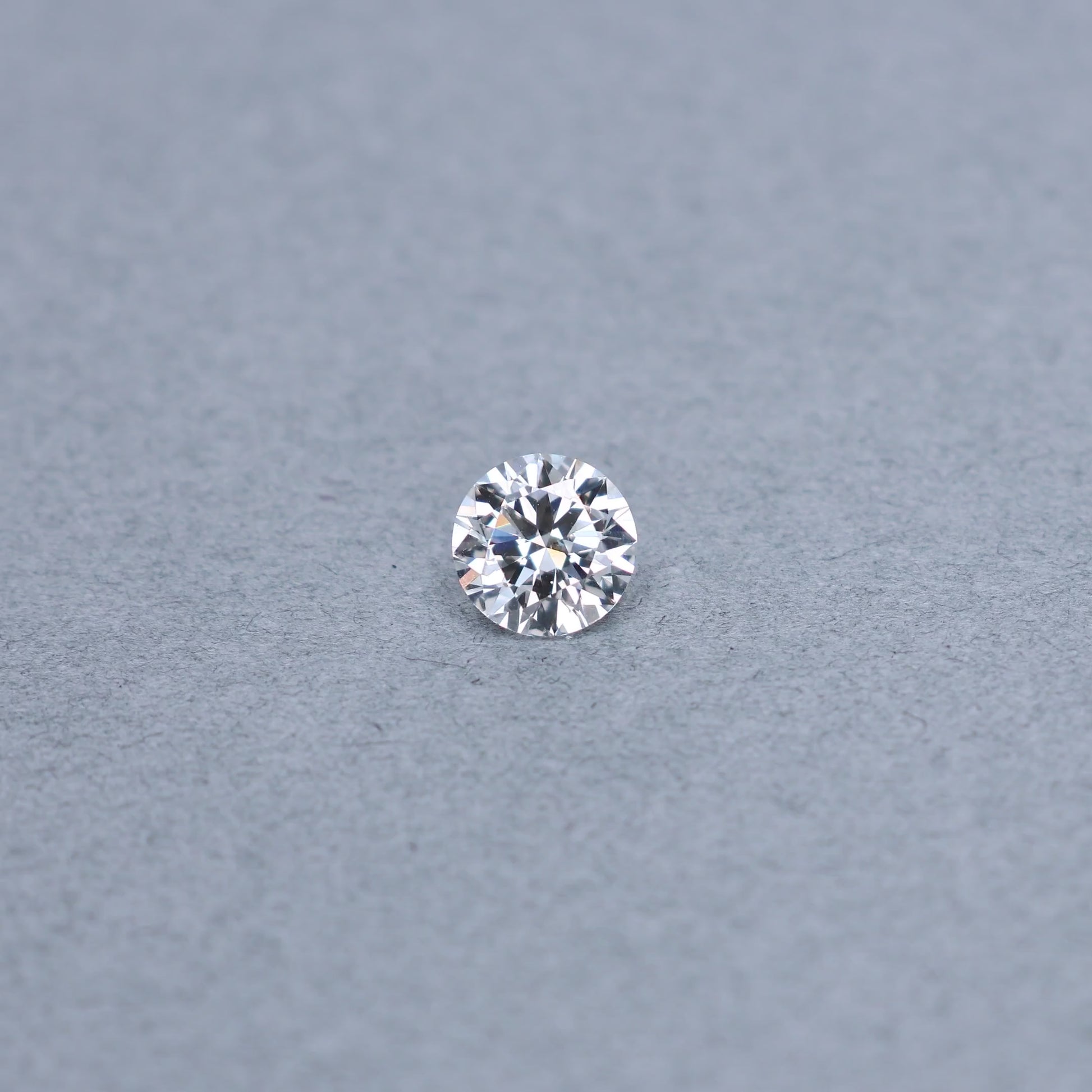 Round 1.50 carat GIA certified diamond graded EVS2 on a grey background