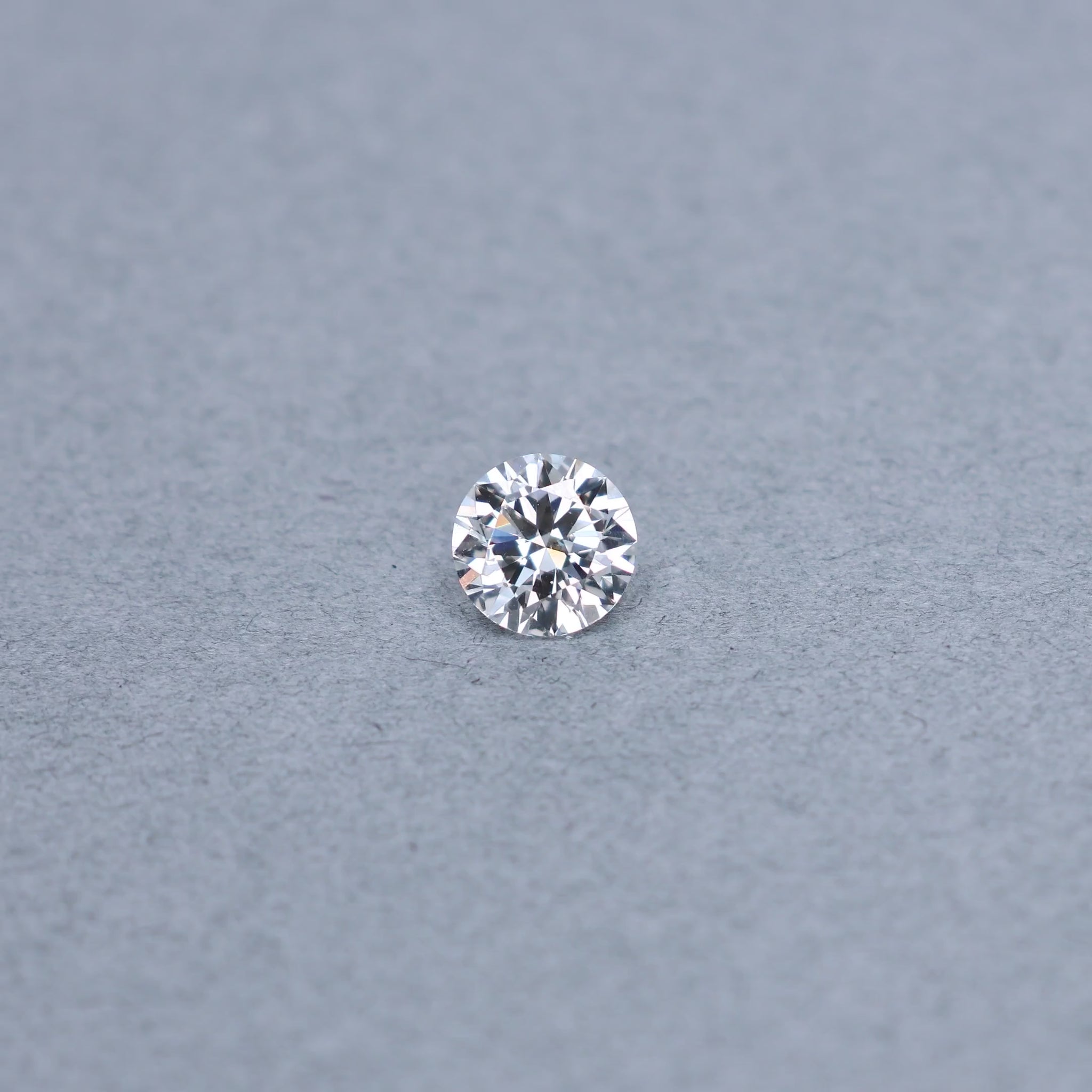 Round 1.50 carat GIA certified diamond graded EVS2 on a grey background